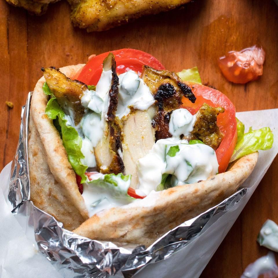 Chicken Shawarma Sandwich · Thin slices of marinated chicken cooked on a slowly revolving rotisserie, served in pita bread with lettuce, tomatoes, onion, pickles, and tahini sauce.