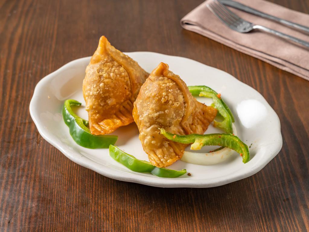 08. Vegetable Samosa · 2 Pieces. Golden crispy triangle pastry filled with mildly spiced potatoes and peas.