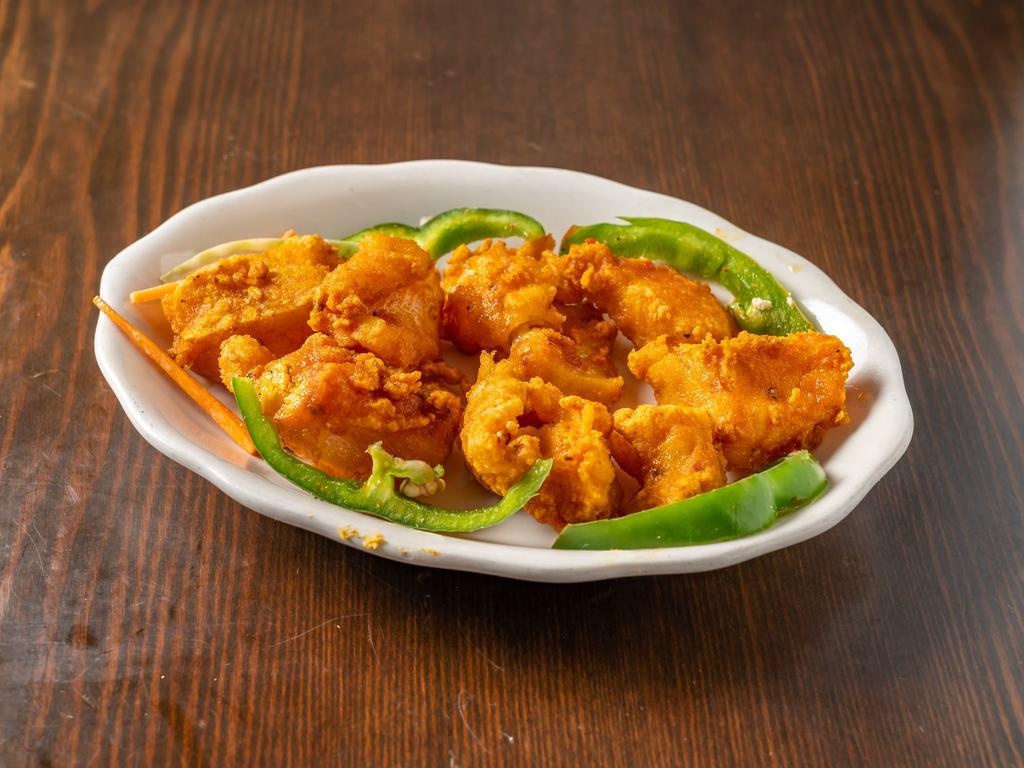 14. Fish Pakora · Boneless fish marinated in batter spiced to your desire and deep fried to a crisp golden color.