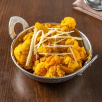 38. Aloo Gobi · Fresh cauliflower and potatoes cooked with onions and tomatoes. Served with long grain basma...