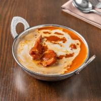 57. Butter Chicken · Boneless chicken slow-simmered in super delicious creamed tomato sauce. Served with long gra...