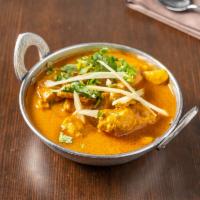 63. Chicken Curry · Savory boneless chicken cooked in delicate gravy of tomatoes, onions, turmeric and other spi...