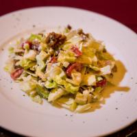 Kirby's Chopped Salad · Iceberg lettuce, granny smith apples, walnuts, applewood smoked bacon, red onions, tossed wi...