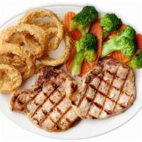 Grilled Pork Chops · Two Grilled Pork Chops served with two sides.
