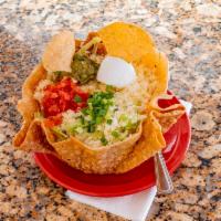 Camaron Taco Salad · Taco bowl with beans, cooked shrimp, topped with lettuce, tomatoes, onions, guacamole, and s...