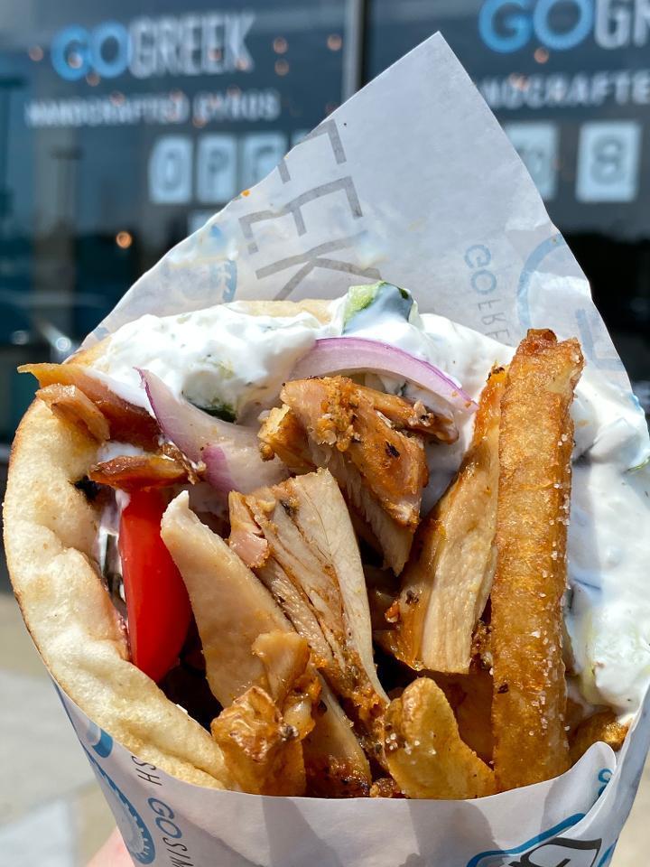 Chicken Gyro · Hand-stacked Chicken Gyro, Tzatziki, Tomato, Onion on a Warm pita bread topped with crispy Fries.