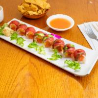 Dynamite Roll · In: spicy tuna, mango, soy paper wrap. Top: pepper tuna and avocado; spicy chili sauce.