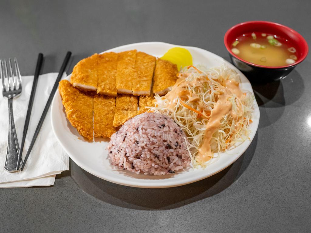 Tonkatsu 돈가스 · Tonkatsu consists of a breaded, deep-fried/tempura pork cutlet. It involves cutting the pig's back center into two-to-three-centimeter-thick slices, coating them with panko, frying them in oil, and then serving with tonkatsu sauce, rice, and vegetable salad.
