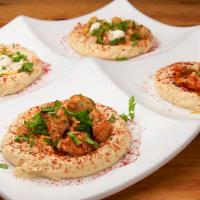 The Hummus Kitchen · Platter divided by 4 types of hummus: sirloin, chicken, chickpea & tahini. Topped with parsl...