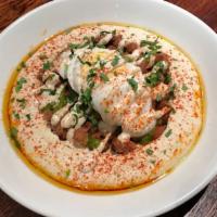Fava Hummus · Egyptian fava beans, hard boiled egg and green sauce. Topped with parsley, paprika, and extr...