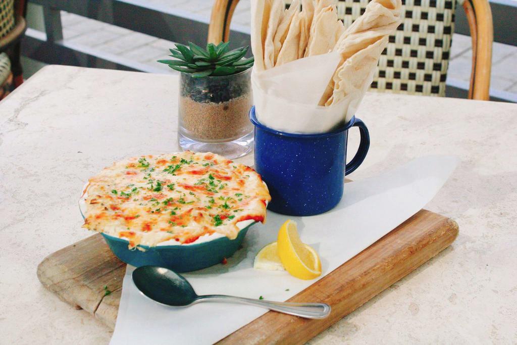Spinach and Crab Dip · Baked spinach, crab, artichokes and cheese blend and pita bread.