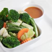 Steamed Veggies · Broccoli, cabbage, carrots, Yu Choy steamed. Served with peanut sauce.