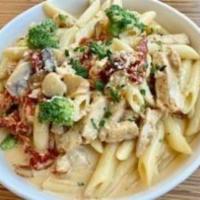 63. Roasted Garlic Penne · Penne pasta, grilled chicken, sun dried tomatoes, broccoli, mushrooms in roasted garlic crea...