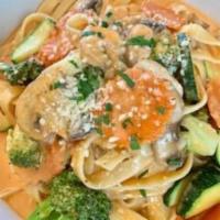 Fettuccine Primavera · Fettuccine pasta, carrots, mushrooms, carrots & zucchini in pink sauce, topped with parmesan...