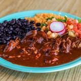 Mole con Pollo · Our unique vegan mole with chunks of fresh chicken breast; served with rice, beans, jicama salad, and tortillas.
