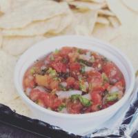 Chips And Salsa. · Fresh corn tortillas with roasted tomato salsa. Queso and Guacamole or Trio for an extra cha...