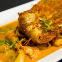 Pescado a la Macho · Assorted seafood in a wine tomato sauce topped with fried panko filet of fish served with fr...