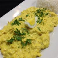 Aji de Gallina · Shredded chicken in a creamy cheese sauce served on halved potatoes accompanied with steam r...