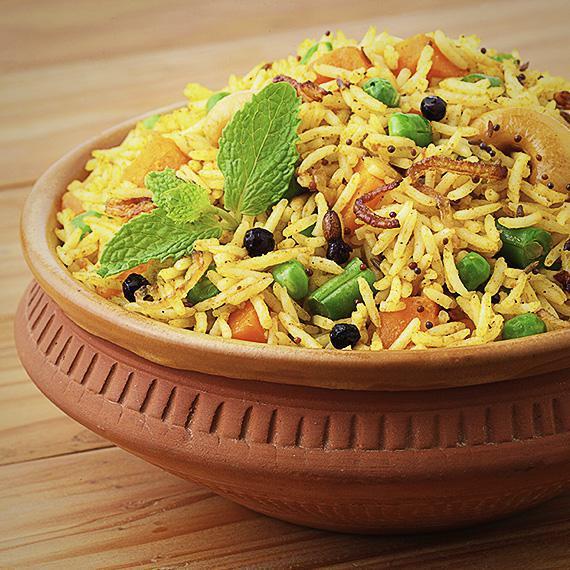 Veggie Dum Biryani · Long grain basmati rice cooked with combo of fresh vegetables, tossed herbs, and exotic spices and garnished with saffron threads.