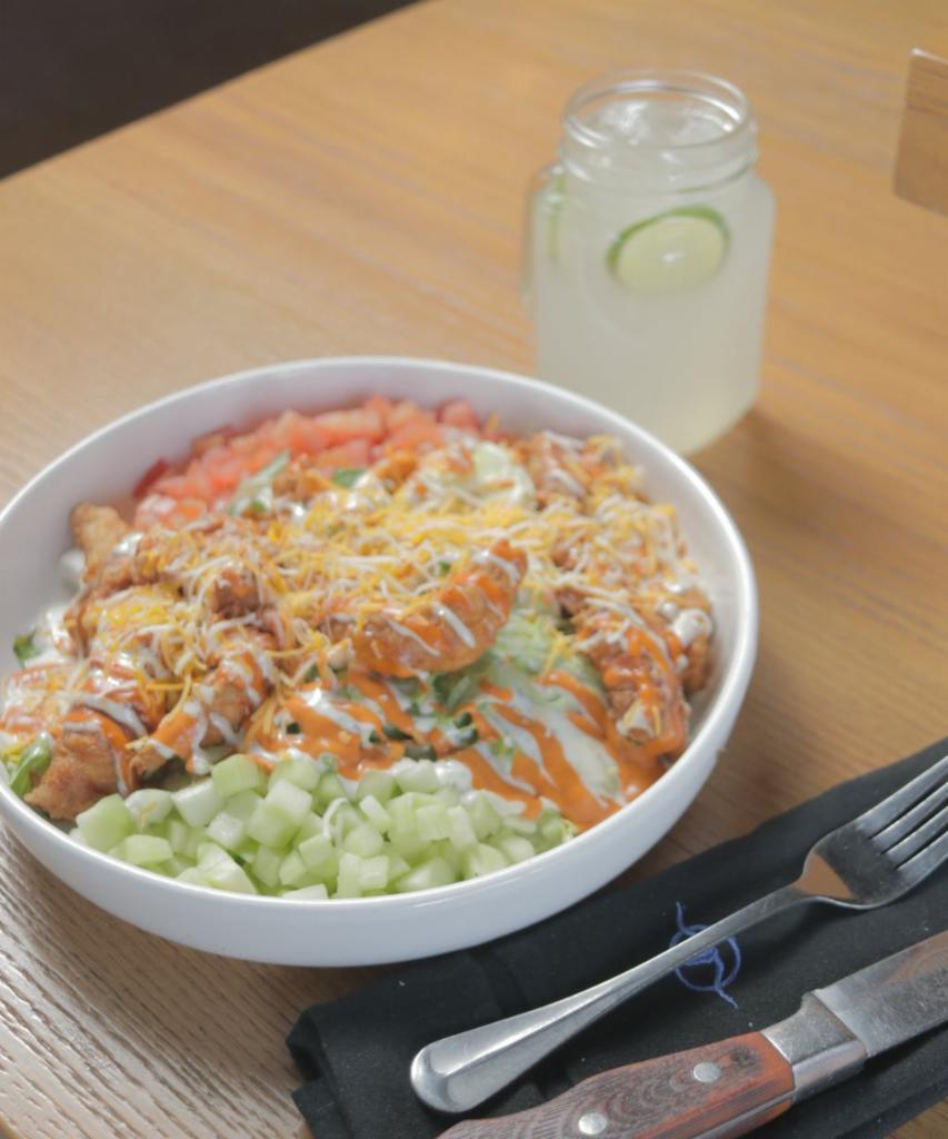 Buffalo Chicken Salad · Iceberg and romaine lettuce topped with Buffalo chicken strips, cucumber, tomato, cheese mix, and ranch dressing.