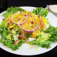 Granny's House Salad · Iceberg and romaine lettuce topped with diced tomatoes, eggs, shredded cheese, banana pepper...