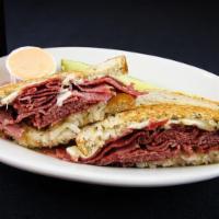 Reuben Sandwich Only · Hot corned beef, Swiss cheese, and sauerkraut on grilled rye. Served with Thousand Islands d...