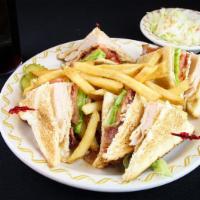 Club Sandwich · Traditional club sandwich served with french fries.