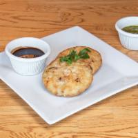 Aloo Tikki chaat · Flash fry potato patty complimented W/chickpeas, onion, tomato & tamarind & mint chutney  