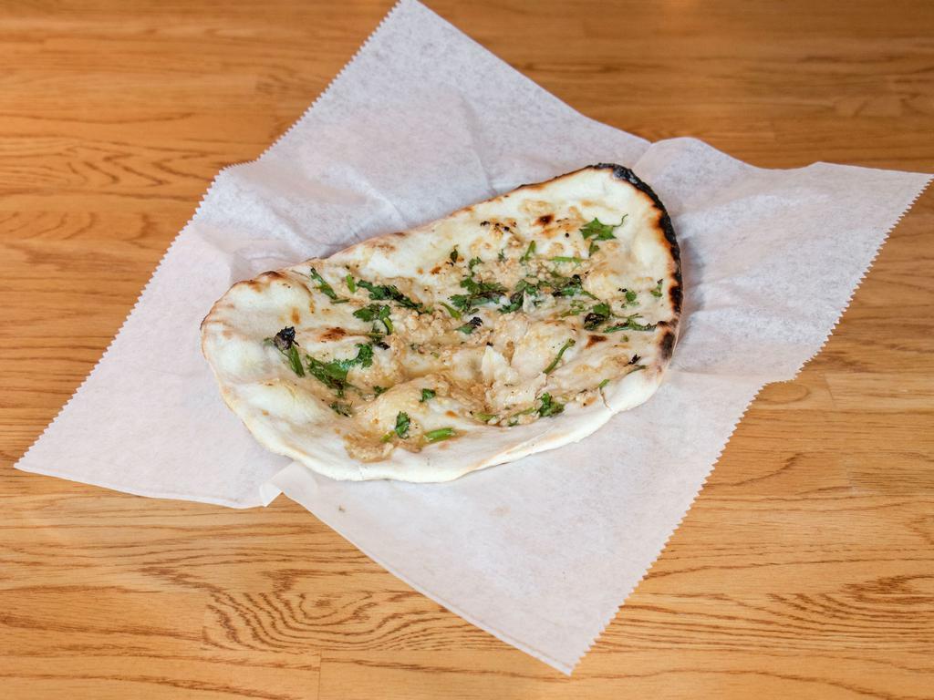 51. Garlic Naan · Whole white bread topped with fresh garlic.