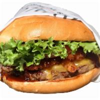 BBQ ONION CHEESEBURGER · Hamburger, onion rings, Tillamook Cheddar Cheese, pickles, lettuce, tomato, bbq sauce, serve...