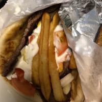 Authentic Greek Gyro Lamb · Wrapped in a pita  fries, raw onions, tomato, tzatziki sauce, mustard and ketchup.