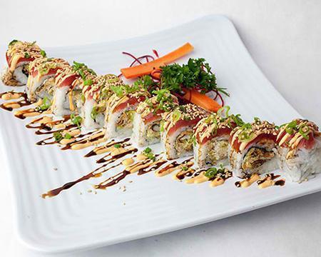 Maui Wowie Roll · Soft shell crab tempura, avocado, cream cheese, topped with tuna, spicy mayo, sweet soy, scallions and sesame seeds.