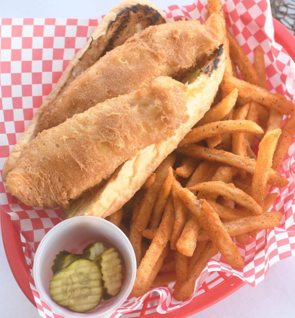 Beer Battered Whitefish Po Boy · Beer Battered white fish fried and served with lettuce, tomato, pickle, and Cajun Mayo on a toasted baguette.