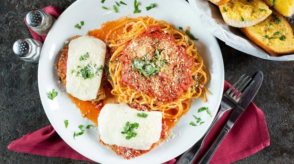 Chicken Parmigiana · Seasoned and breaded chicken breast baked with marinara sauce, topped with mozzarella and Parmesan. Served with a side of spaghetti.