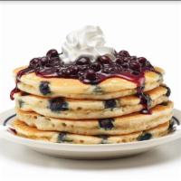 Double Blueberry Pancakes · Double the blueberries, double the taste! Four fluffy buttermilk pancakes filled with bluebe...