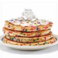 Cupcake Pancakes · Four buttermilk pancakes filled with festive rainbow sprinkles. Topped with cupcake icing & ...