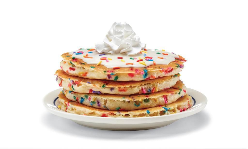 Cupcake Pancakes · Four buttermilk pancakes filled with festive rainbow sprinkles. Topped with cupcake icing & more sprinkles.