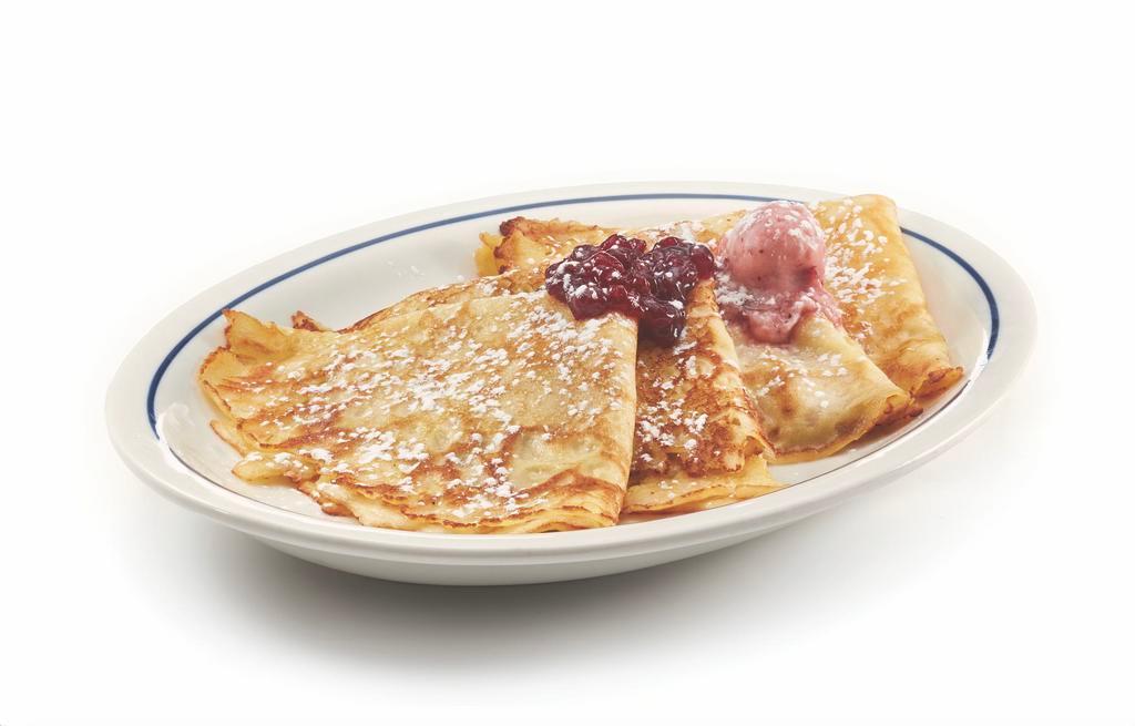 Swedish Crepes · Four delicate crepes topped with sweet-tart lingonberries & lingonberry butter.

