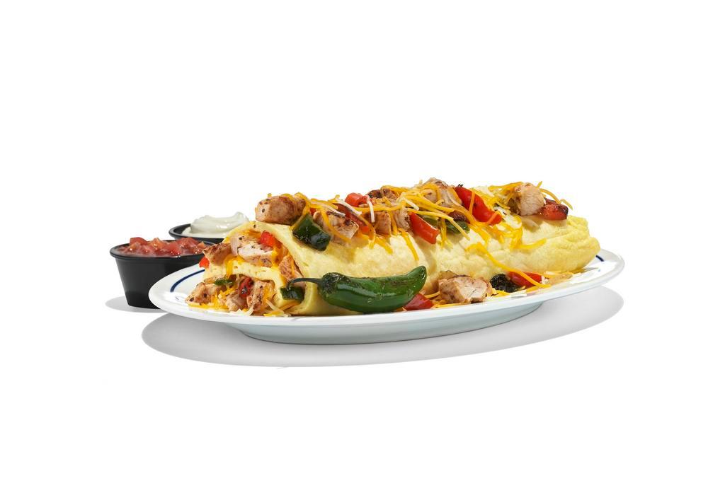 Chicken Fajita Omelette · The perfect fiesta in one package. Our omelette stuffed with grilled chicken breast with Poblano & red bell peppers, roasted onions & Jack & Cheddar cheese blend. Served with salsa, sour cream & grilled Serrano pepper.

