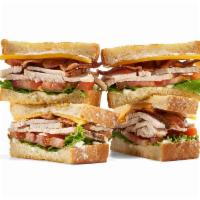 Turkey Cheddar Club · Carved roasted turkey breast, White Cheddar cheese, custom-cured hickory-smoked bacon, lettu...