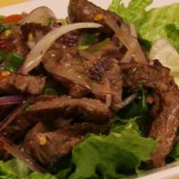 5. Yum Nua Salad · Grilled sliced flank steak, red onions, cucumber, and mixed greens tossed in spicy lime dres...