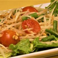 6. Som Tum Ma la Gore Salad · Julienned green papaya, roasted peanuts, tomatoes, and string beans tossed with spicy lime d...