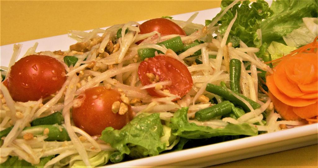 6. Som Tum Ma la Gore Salad · Julienned green papaya, roasted peanuts, tomatoes, and string beans tossed with spicy lime dressing. Spicy hot.