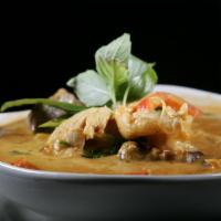 61. Red Curry · Choice of meat mixed with rich red curry paste, coconut milk, bell peppers, green beans, egg...