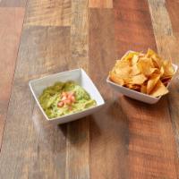 Guacamole and Chips · Avocado, onions, cilantro, jalapeno pepper, lime and homemade corn chips in a mortar stone.