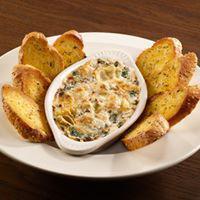 Spinach Artichoke Dip · Fresh sauteed spinach blended with artichokes, mozzarella and Parmesan in a creamy sauce top...