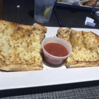 Garlic Cheese Bread · French bread topped with melted mozzarella, then baked. Served with a side of Mellow red sau...