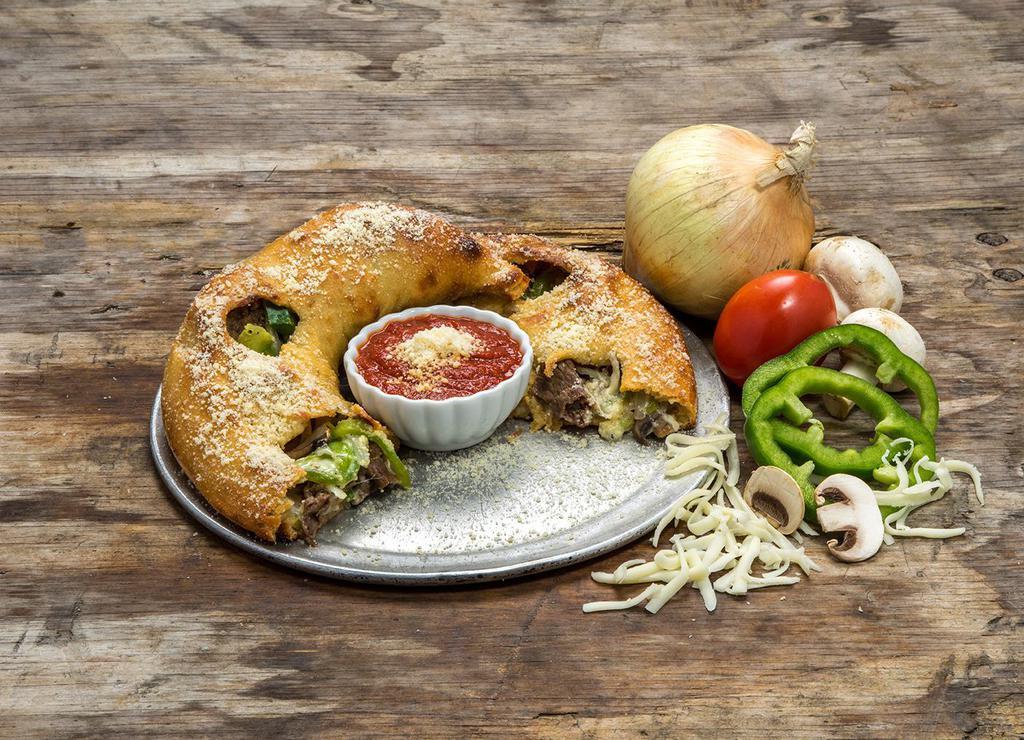 Steak and Cheese Calzone · Grilled, shaved all natural ribeye steak with mushrooms, onions, green peppers, seasoned ricotta, mozzarella and provolone. Made with fresh Mellow dough and served with a side of Mellow red sauce.