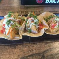 Baja Fish Style Taco · Crispy fish, lime-cilantro slaw, chipotle mayo, and pico de gallo.