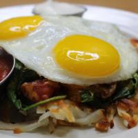 Georgia’s Potatos Deluxe · Hash browns stuffed with spinach, mushrooms, onion, green chiles, and tomato. Served with to...